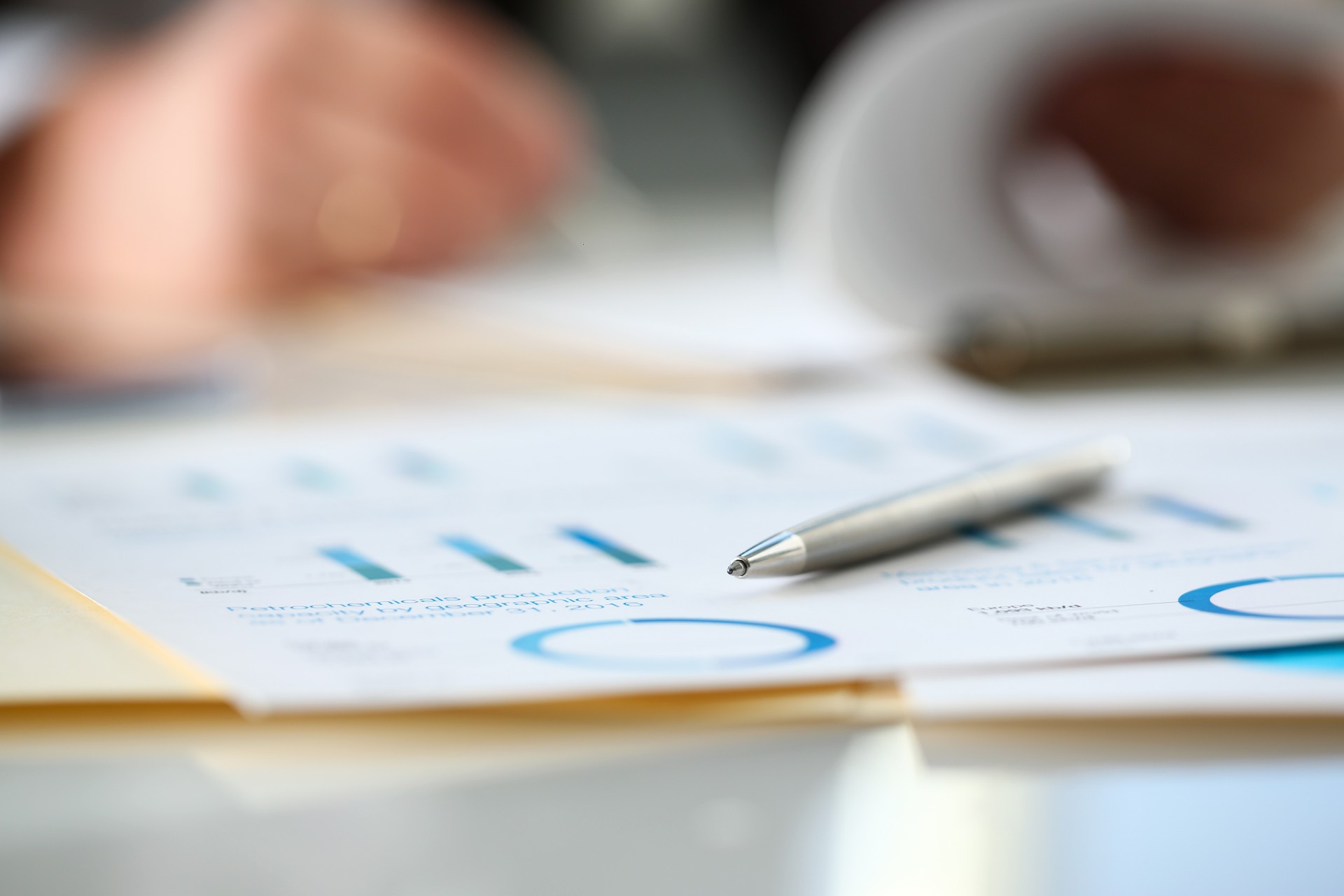 close up of professionals writing on a notebook